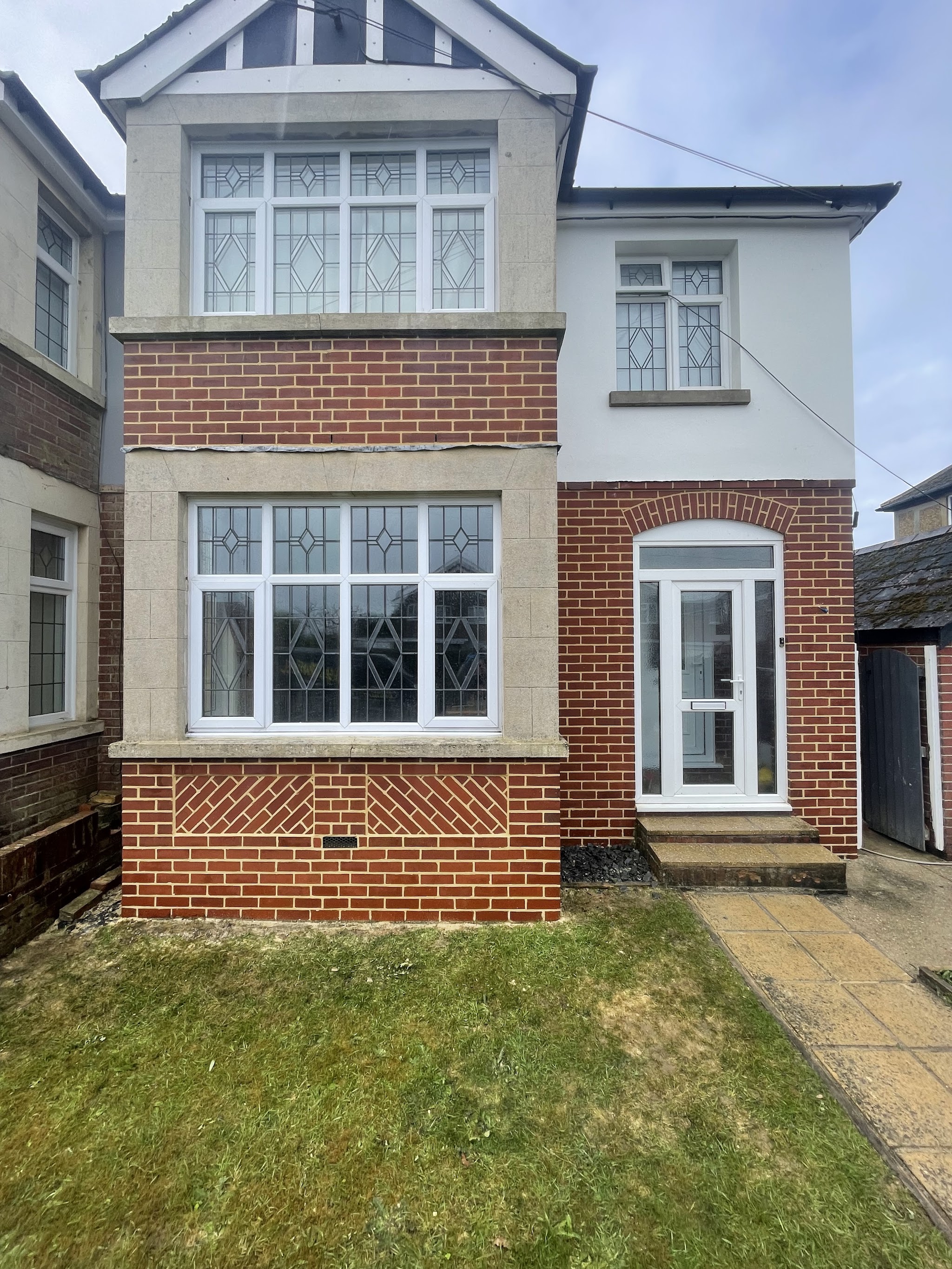 1930s semi with repointed red brick bays
