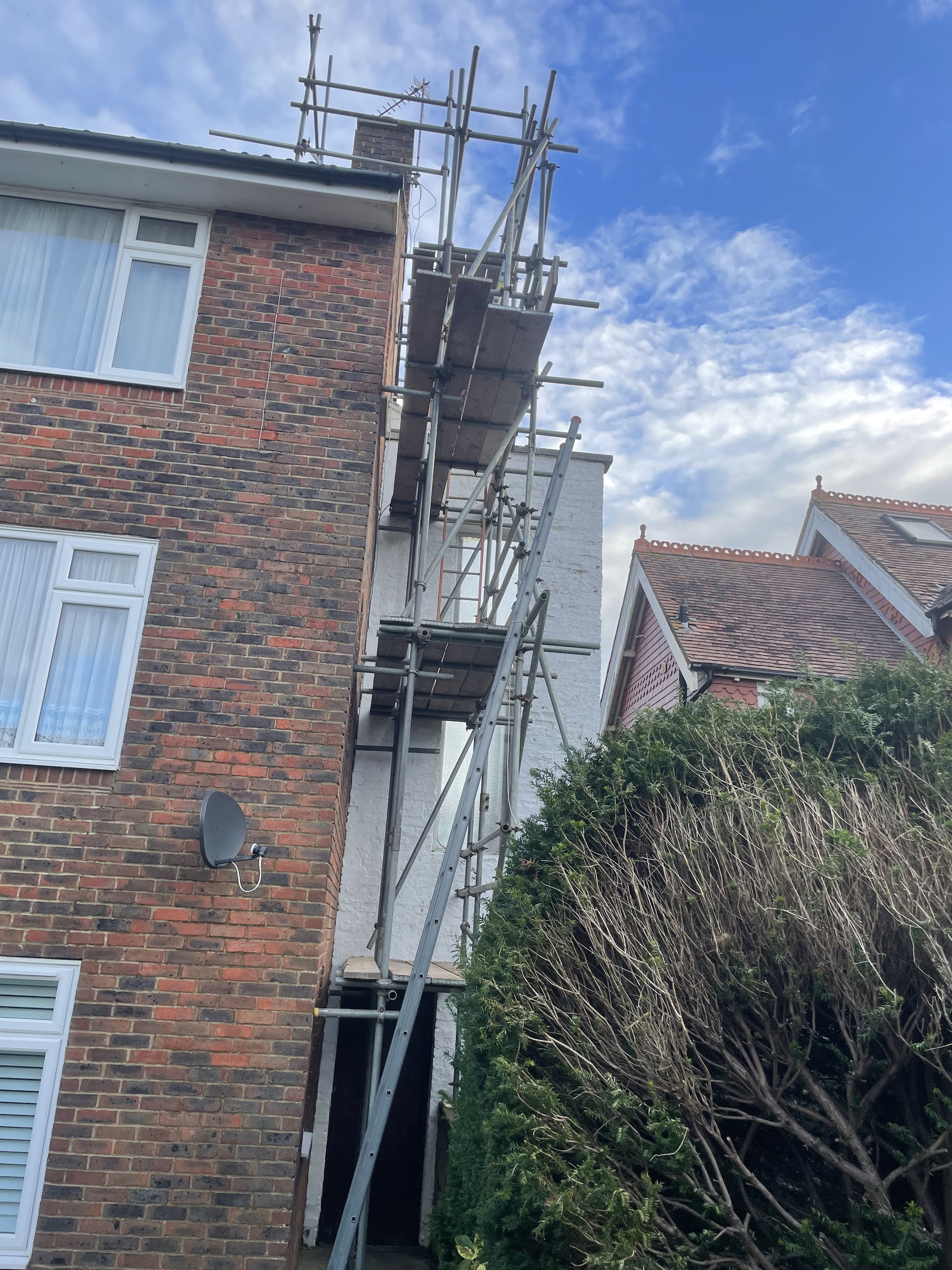 Scaffold up the side of a brick house